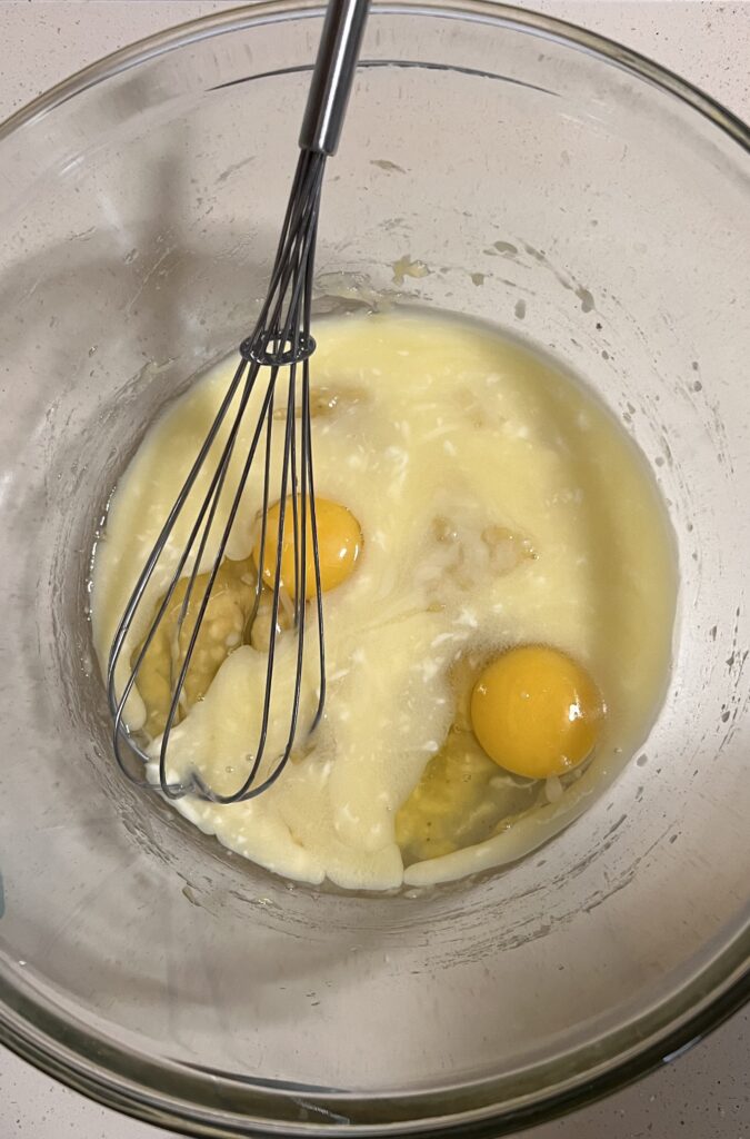 Add eggs and butter to mashed bananas