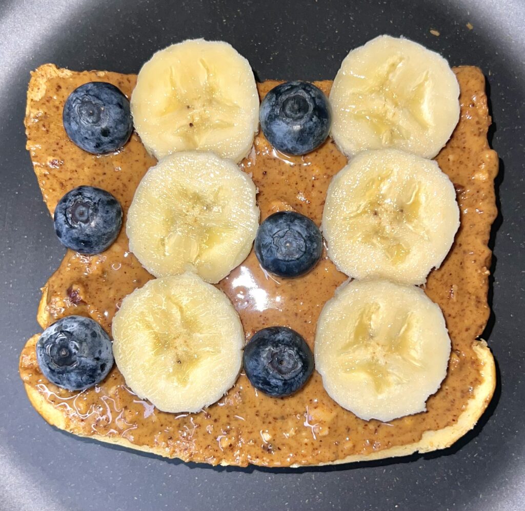 Brioche with almond butter, banana, blueberries