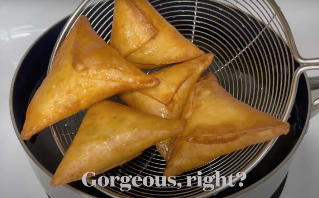 Draining samosa off the oil