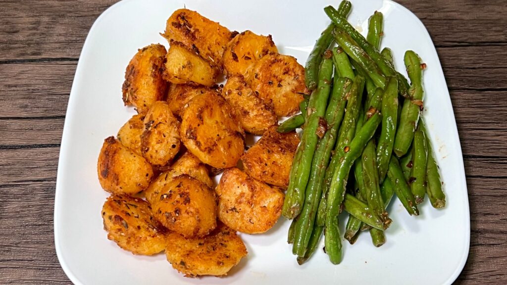 Green beans and roasted potatoes on a plate